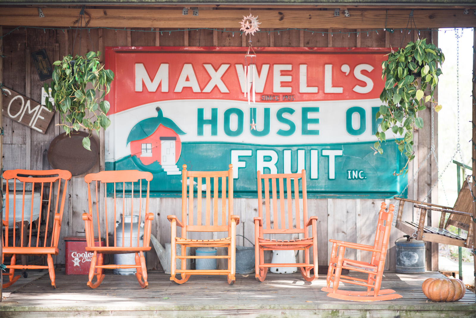 Porch with orange rocking chairs at Maxwell Groves