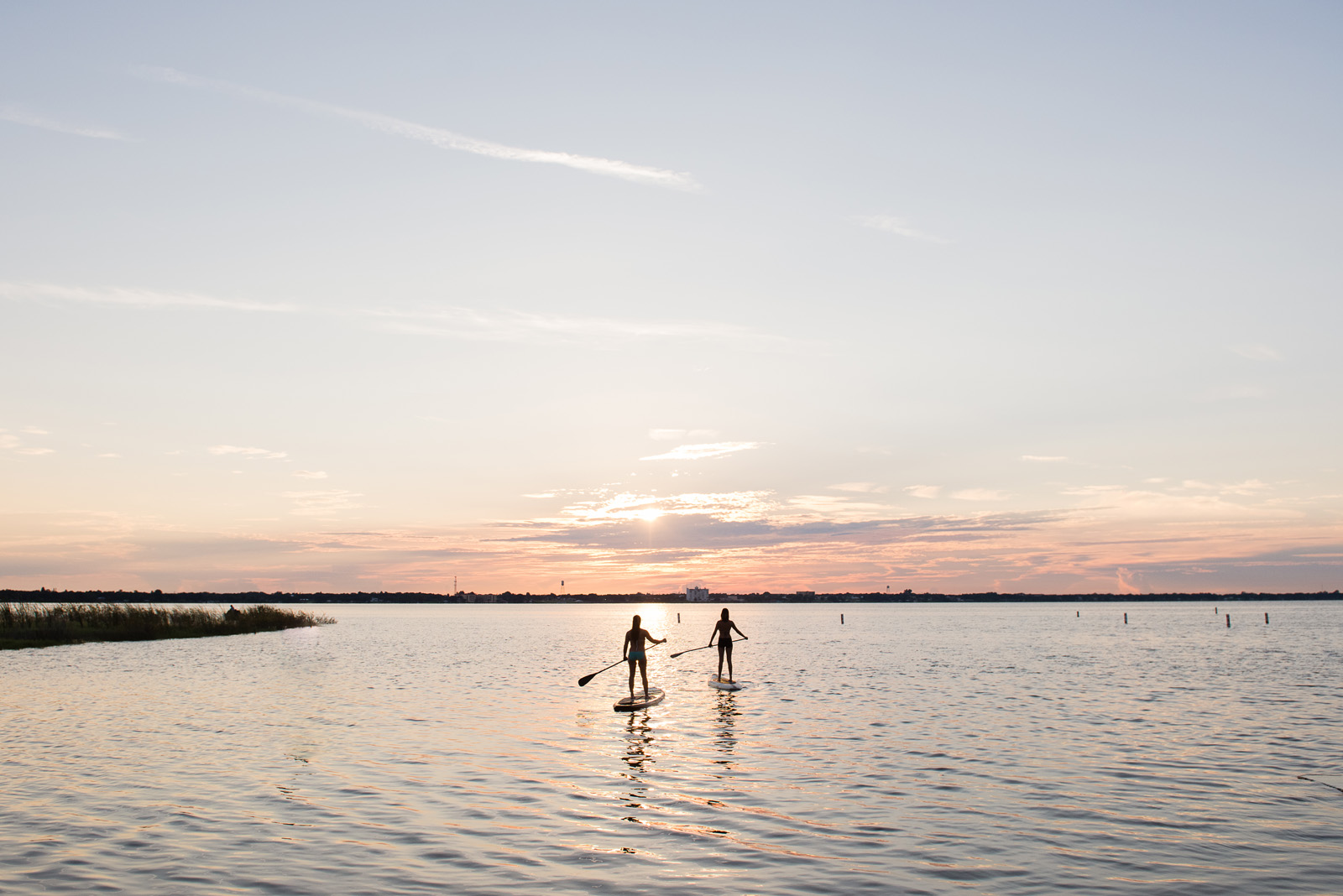 Two people paddle boarding at Lake Jackson at sunrise