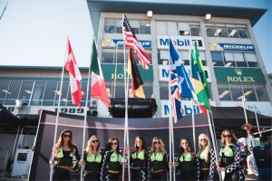 Group of women in front of country flags