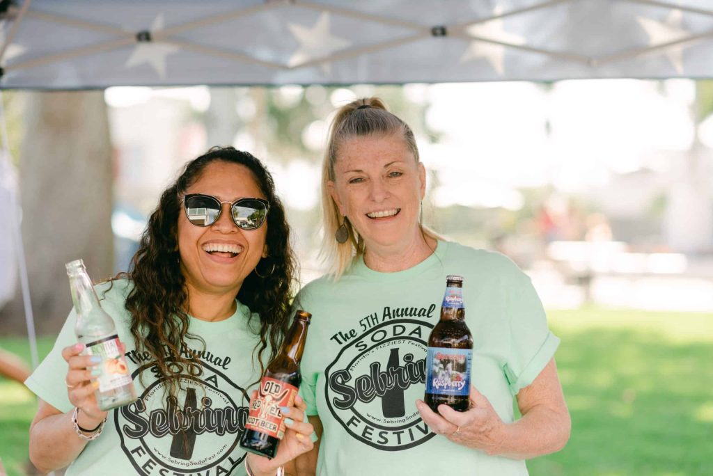 Two women holding bottles at Sebring Soda Festival