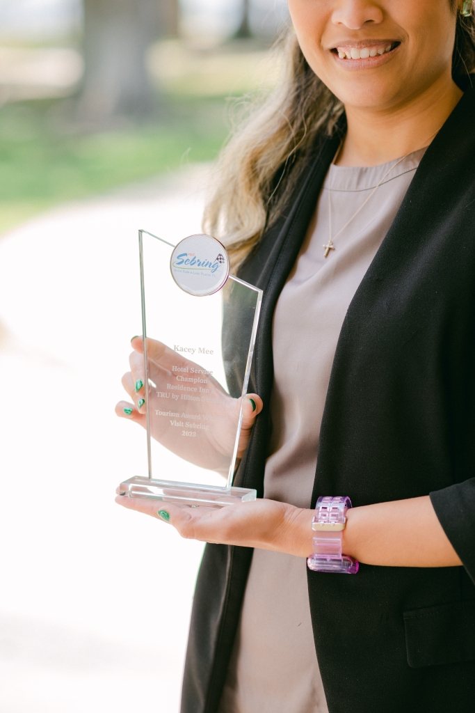 Tourism award being held in the hands of previous winner.