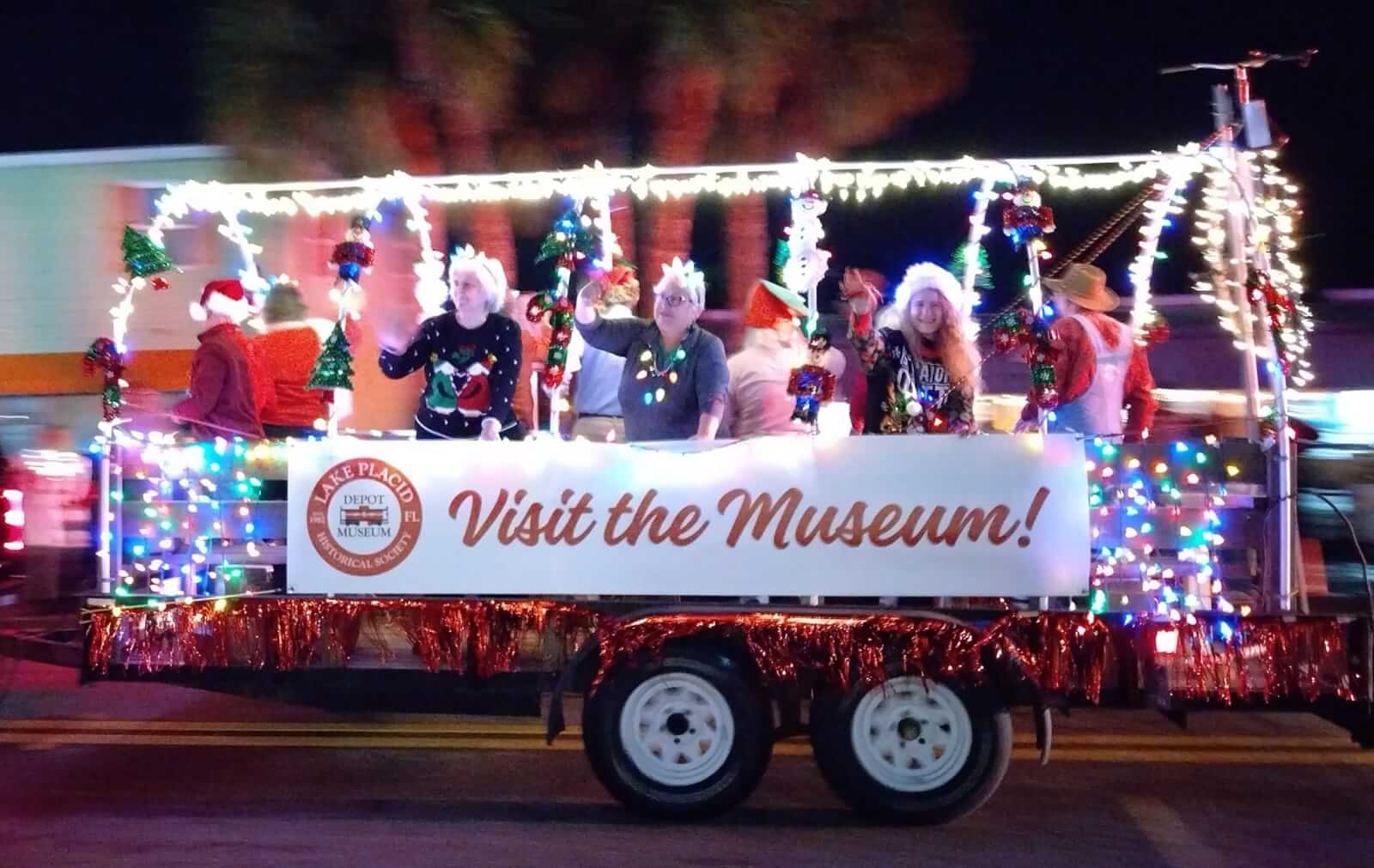 482233311 940223861647081 1292852868328378025 n-visit-sebring-fl People waving from a Christmas float in the Lake Placid, FL Christmas Parade