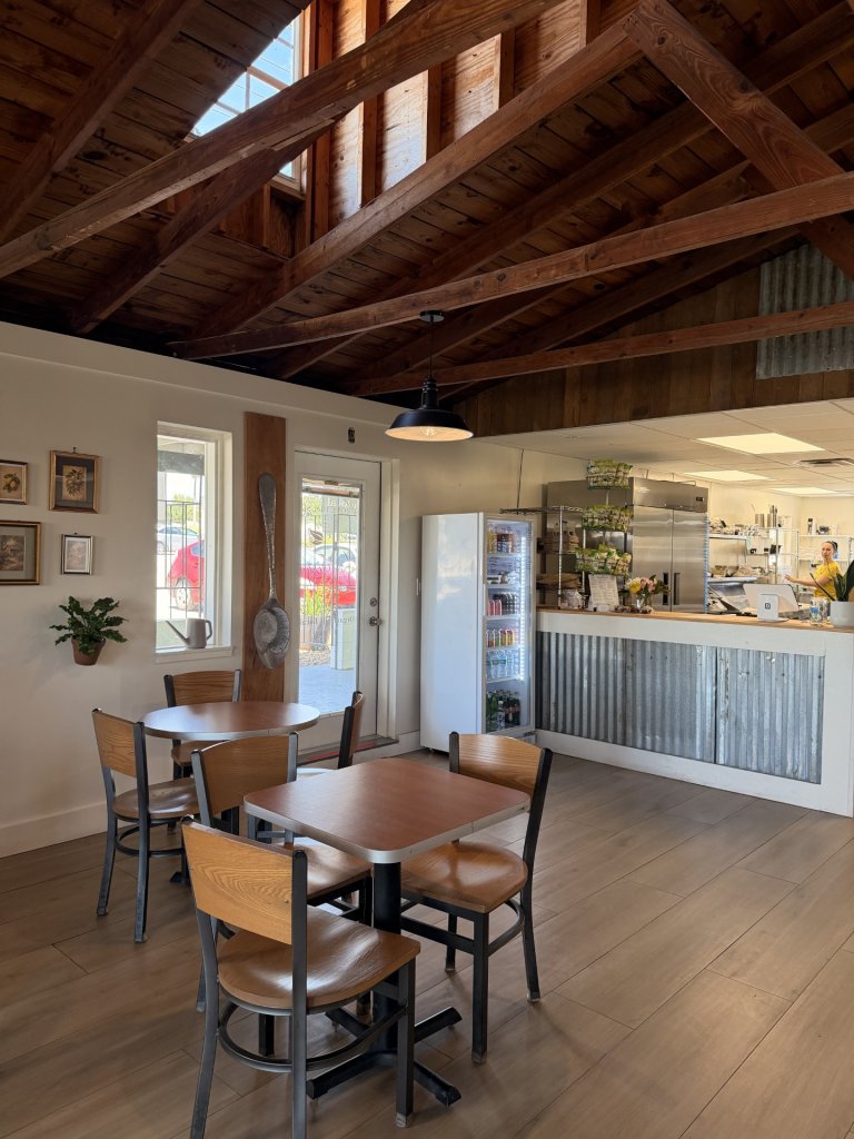 GHCC-visit-sebring-fl Ceiling window letting light into a bright room with wooden beams, more wooden seating areas, and an open kitchen concept.