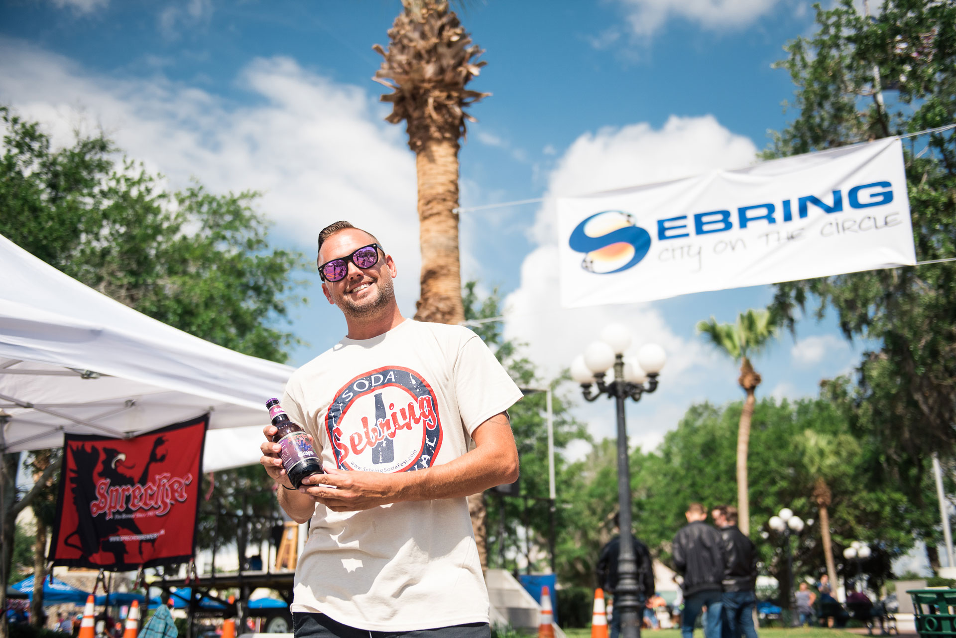 A man holding a soda at the Sebring Soda Festival.
