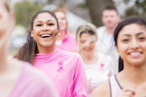 Joggers running in charity race wearing pink