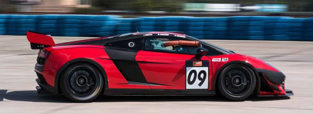 SIR FARA-visit-sebring-fl Red street sports car equipped for track racing and showing number 09 on door speeding down Sebring International Raceway's track
