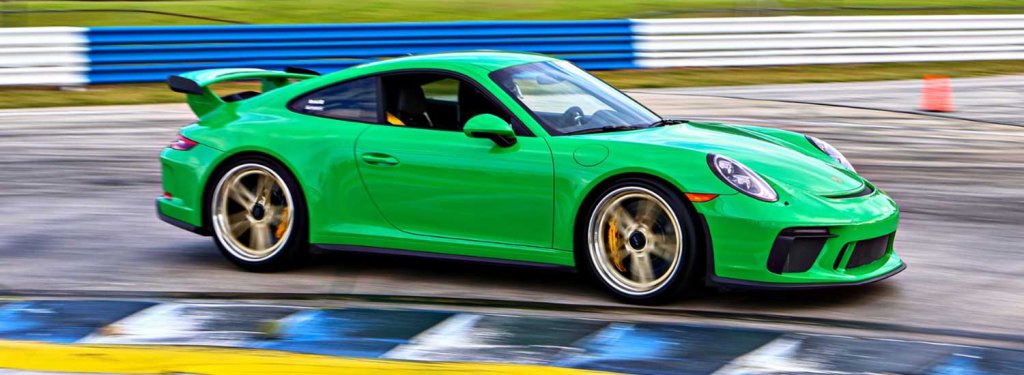 SIR SCCA-visit-sebring-fl Bright green Porche racing on Sebring International Raceway as part of Sport Car Club of America's Track Night Across America event in Sebring, FL