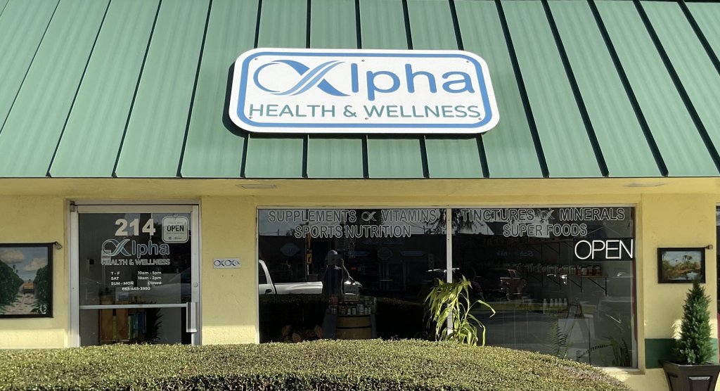 Exterior of a health and wellness store, with big windows showing inside of business and a green roof.