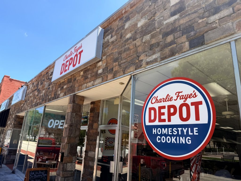 charlie-visit-sebring-fl Outside brick exterior of restaurant storefront with vinyl sticker with restaurant name.