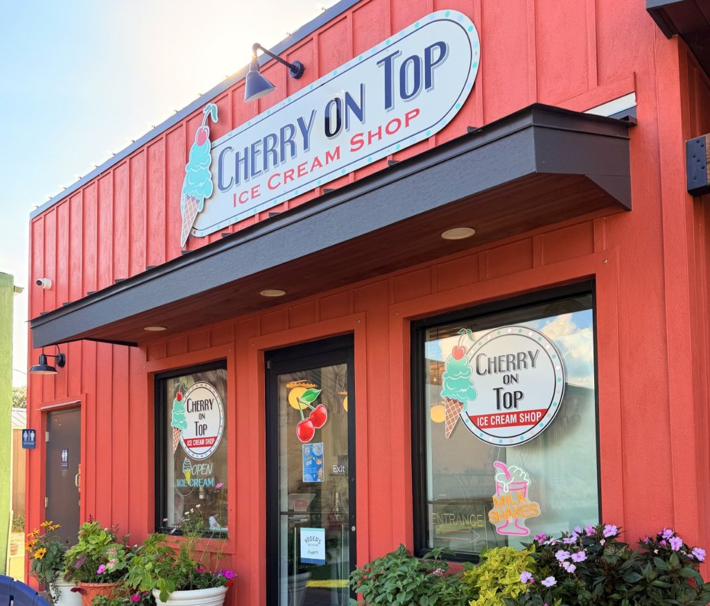 cheryyyy-visit-sebring-fl Outside storefront of Cherry on Top in Lake Placid. A red building with signage of the name of the establishment on top.