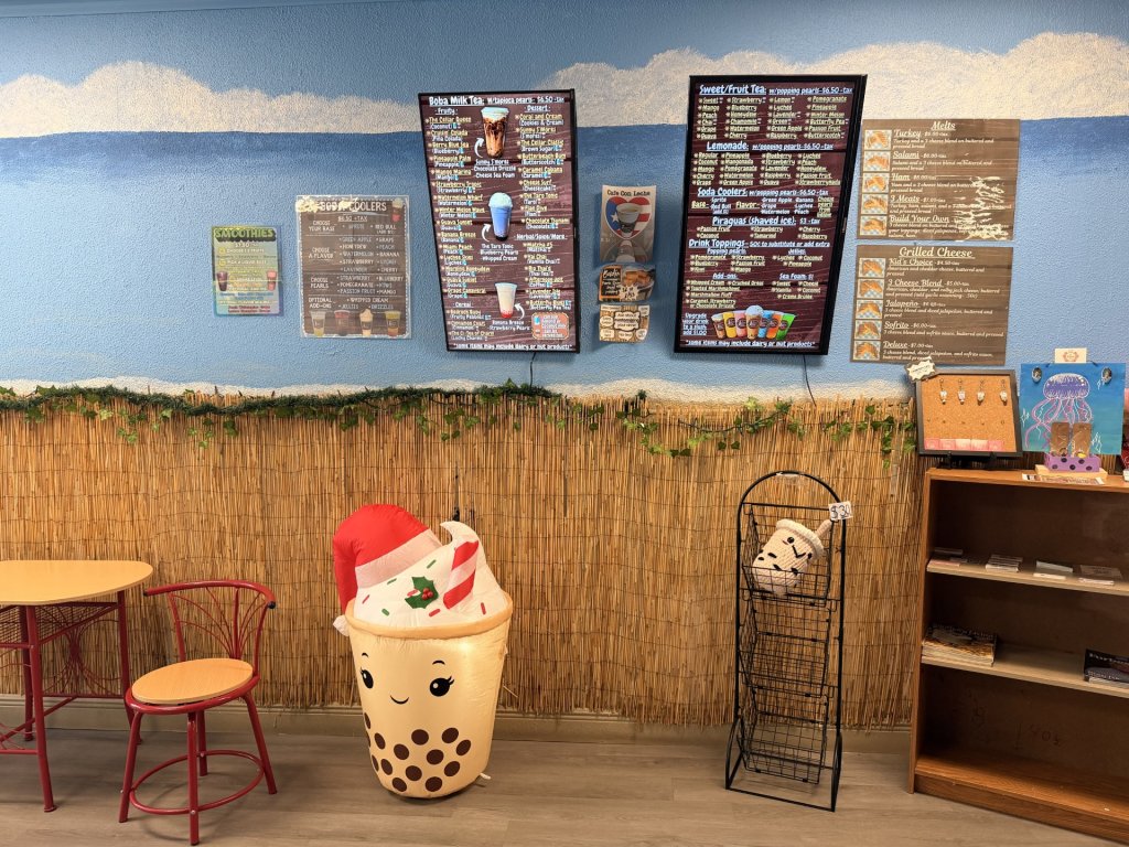 Beach like walls with menus pinned to wall on mounted TVs and printed media. 