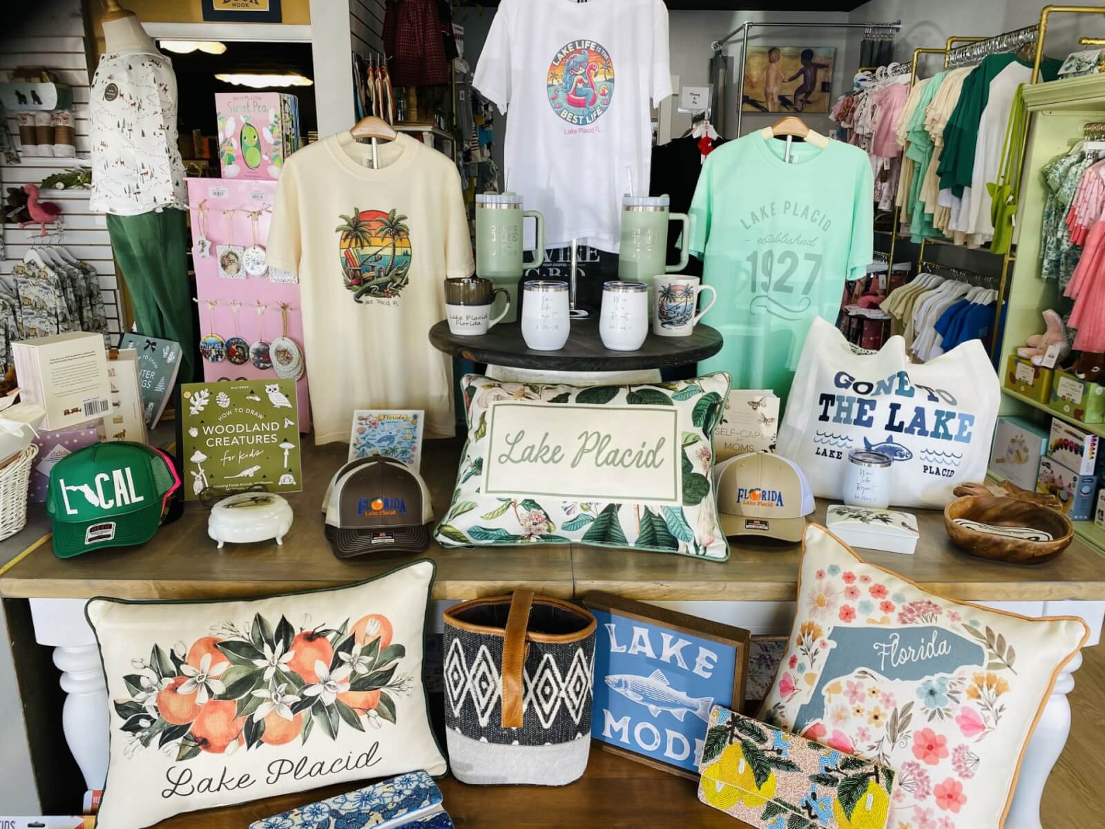 muddd-visit-sebring-fl A table display featuring Lake Placid memorabilia, keepsakes, and clothes arranged for shoppers.